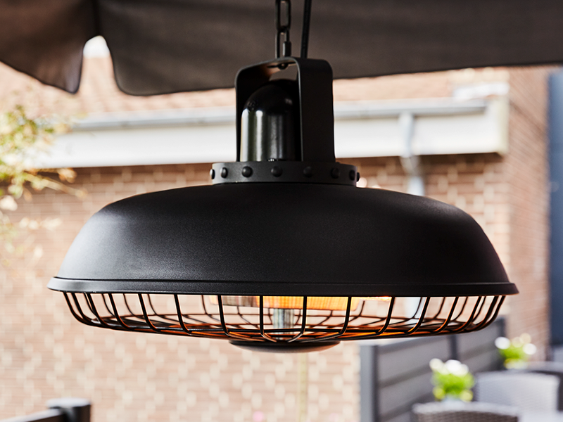 A suspended, infrared patio heater from HORTUS in a raw and industrial look.